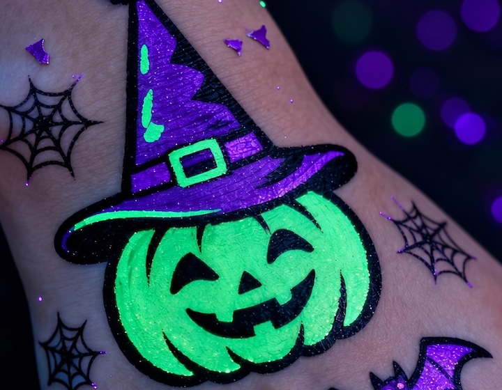 a glow in the dark halloween pumpkin body art