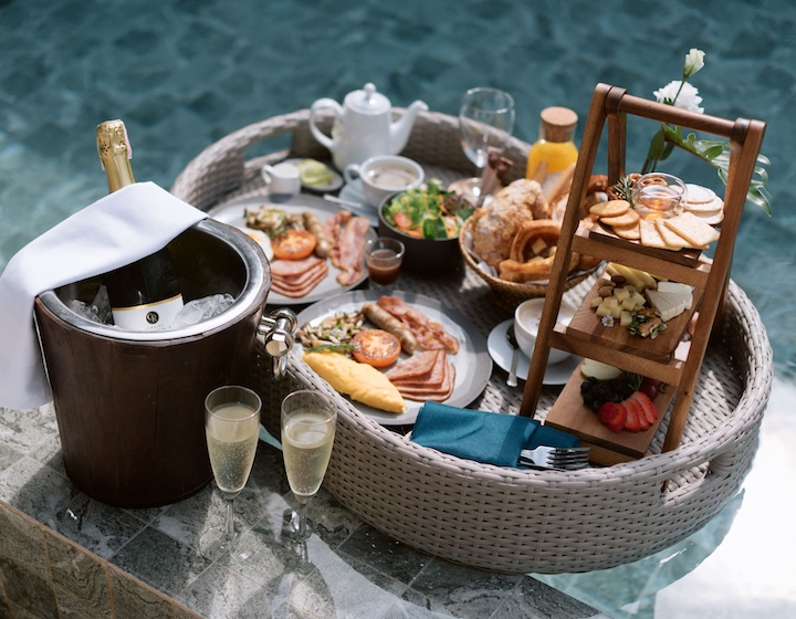 poolside dining set up including champagne and charcuterie at Villa Alanna in Phuket Thailand