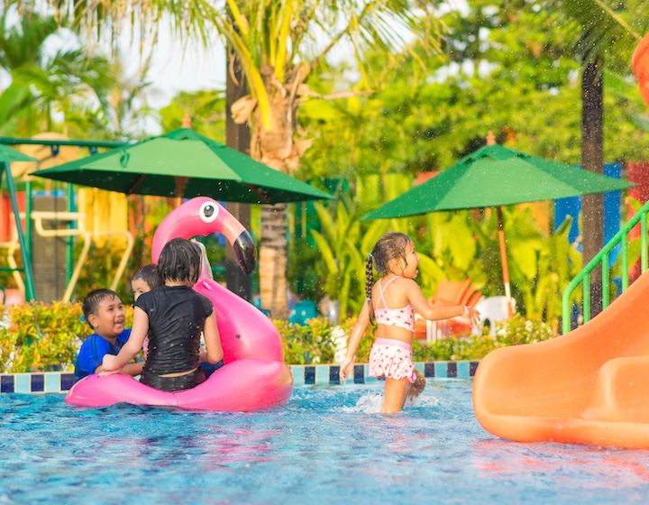children play in a swimming pool at rawai water park in phuket