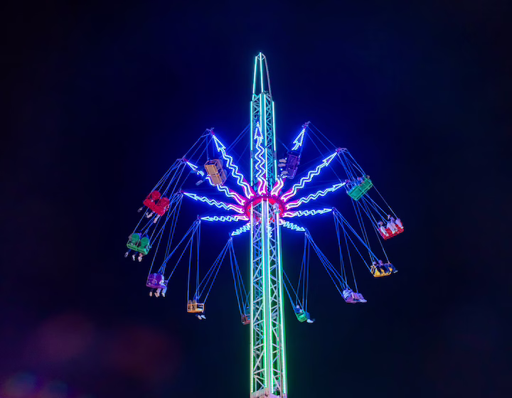 the swing chair ride at AIA Carnival lit up against the night sky