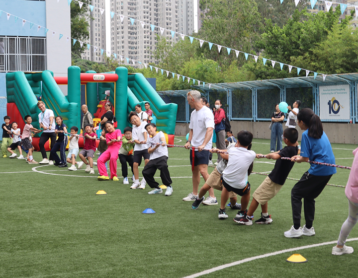 students and teachers playing Tug of War at an Open Day at American School Hong Kong