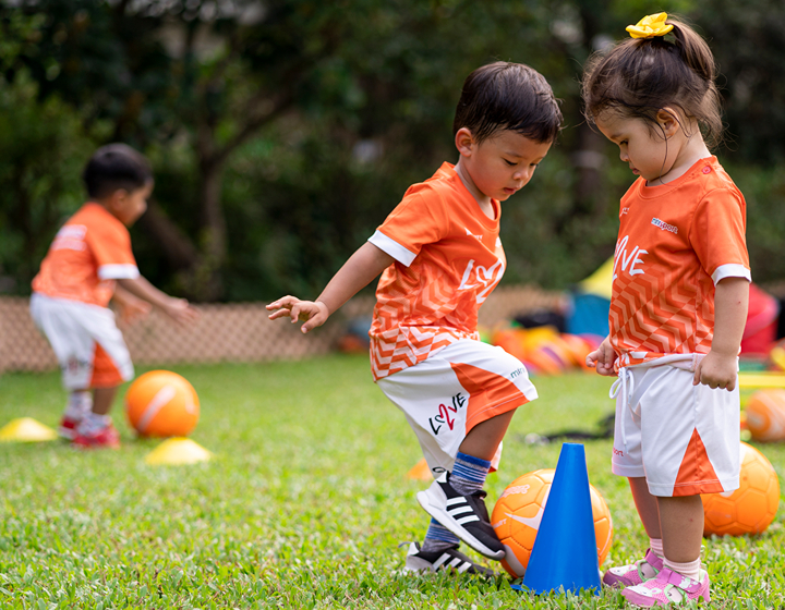 kids playing sports in a park through Minisports playgroup for kids in Hong Kong