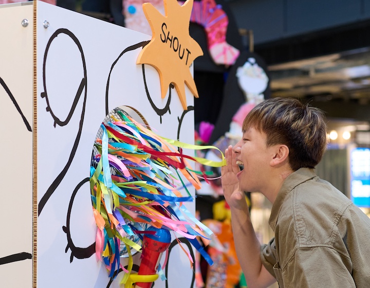 a young man shouts into an immersive art exhibition at weave and shout! at The Mills Hong Kong