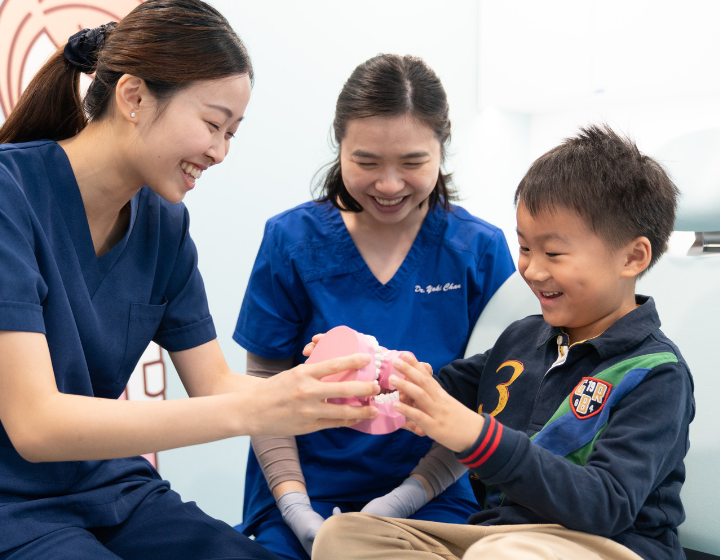 Home Dental dentist explaining oral care to a child patient in Hong Kong