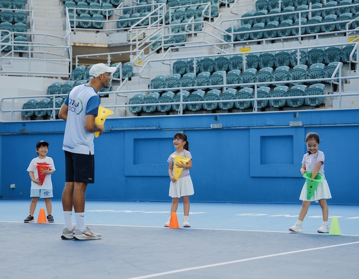 three young children learn basic tennis skills without a racquet at catala sports Hong Kong