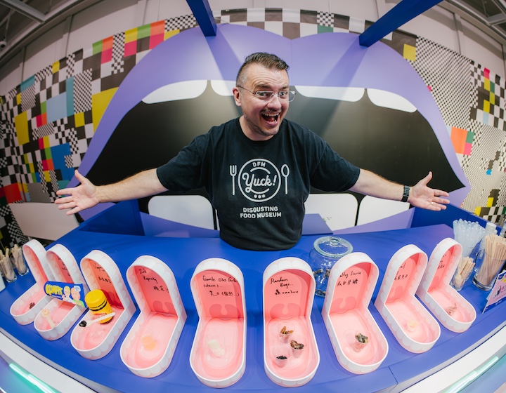 the founder of disgusting food museum Hong Kong poses with food samples