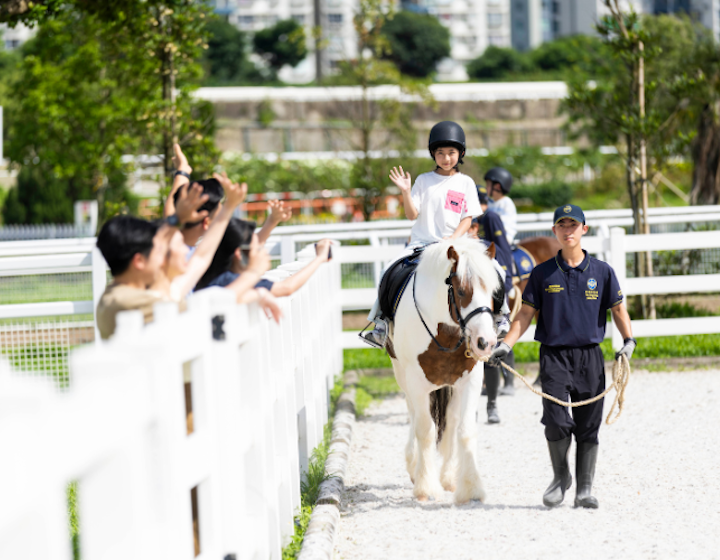 girl rides a horse at pony world at Penfold Park, Sha Tin Racecoursese